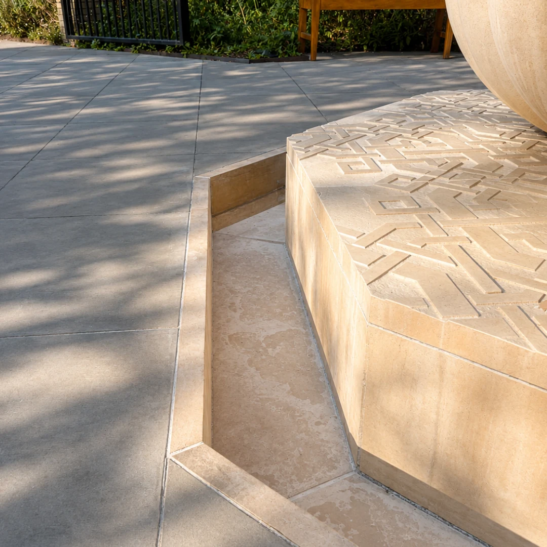 Cambridge Central Mosque limestone fountain after repair, with the restored stone edge