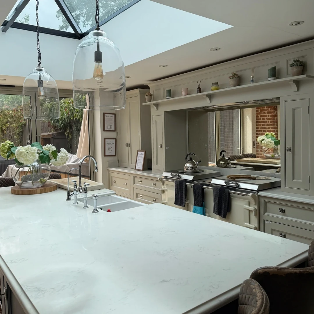 Kitchen with a pale stone worktop and island