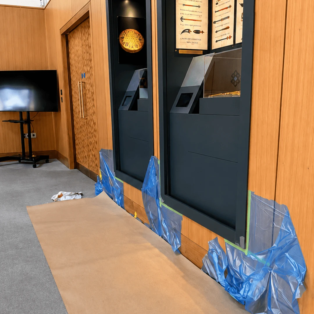 Exhibition display frames during restoration, with protective sheeting and floor covering